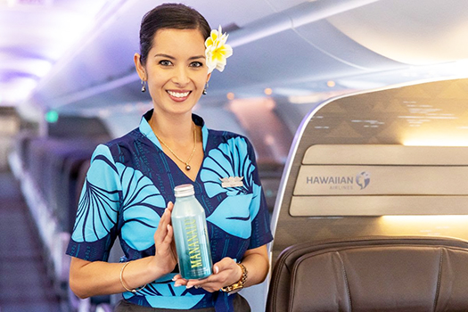 HAWAIIAN AIR FLIGHT ATTENDANT WITH WATER BOTTLE