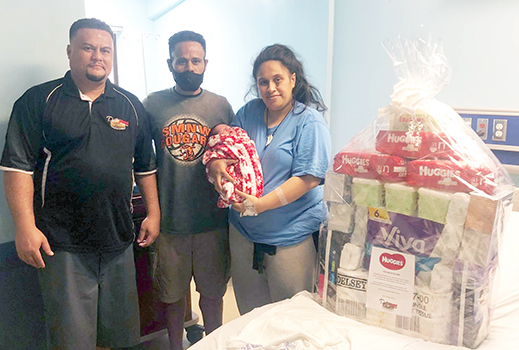 Lisale and Fiatuina Polevia with their newborn and a representative from Pacific Independent Distributors, Inc. 