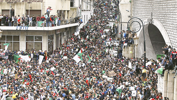 people gather for a demonstration in Algiers to protest President Abdelaziz Bouteflika's hold on power.