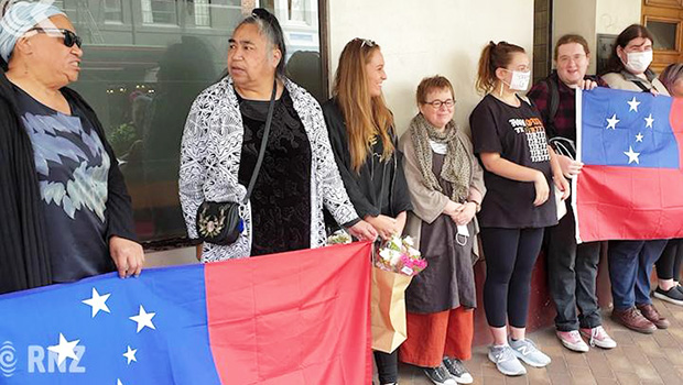  A protest over the cartoon in Dunedin with people holding flags. 