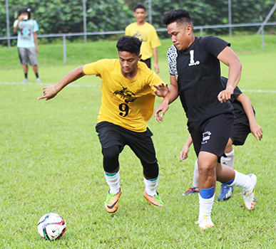 A Pago Youth player (left) and Tafuna Jets opponent 