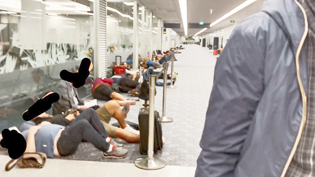 Passengers sleeping on floor at Auckland airport