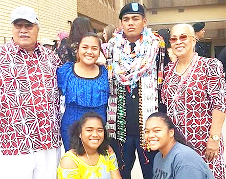Pfc. Washington Pou Ameperosa stands for a picture with three sisters and his grandparents 