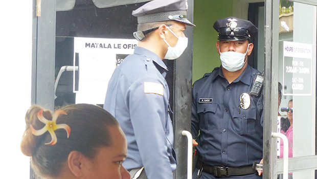 The two police officers exiting DHSS office