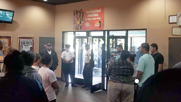 Police standing by the front door as movie goers file out of the Theatre