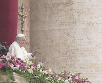 Pope Francis waves to faithful