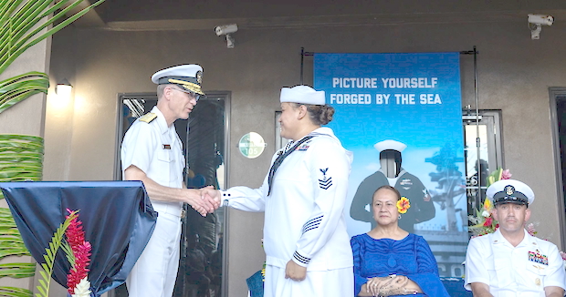 Rear Adm. Richard Meyer gives coin to Navy Counselor 1st Class Alesana Faanofoilefagaoalii