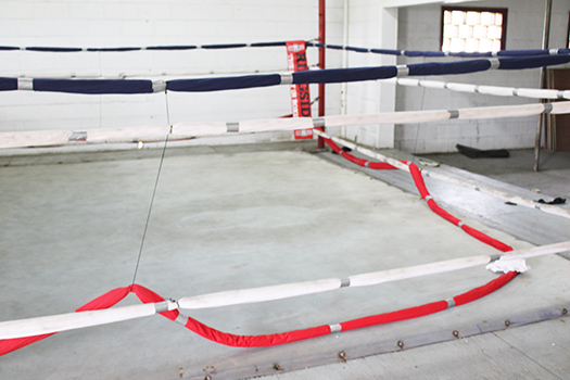 Ring rope cut and laying on floor of boxing ring