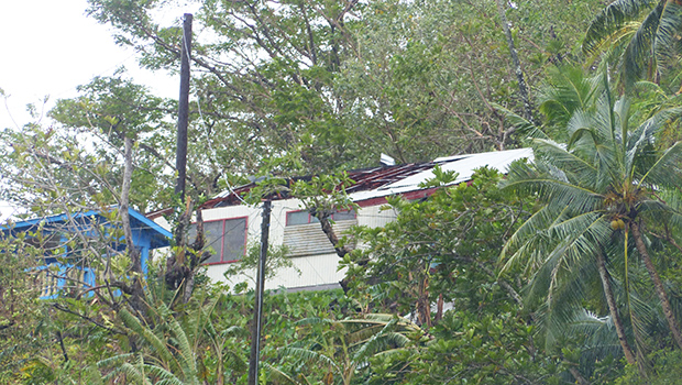 House with roof damage in Fagatogo