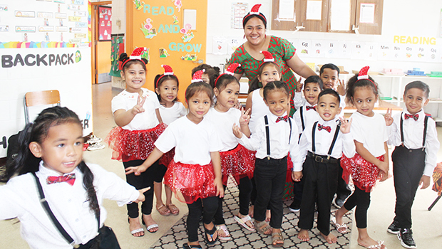 Room 4 students at Fatuoaiga Montessori School with their teacher all in Christmas finery