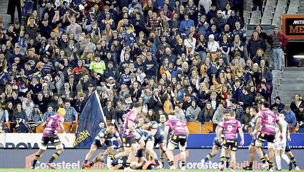 Rugby match in New Zealand with fans in the stands