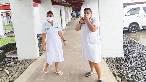 Two nurses in Samoa wearing masks during the measles epidemic