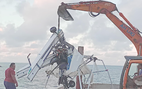 plane crash debris being lifted from the sea