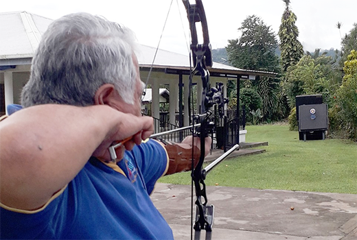 Samoan Prime Minister Tuilaepa Aiono Sailele Malielegaoi aiming to shoot an arrow