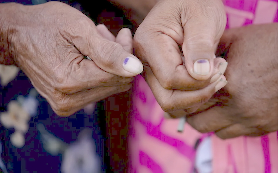 Voters showing the mark indicating they had voted