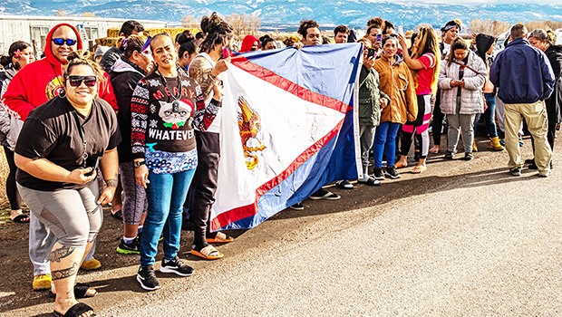 American Samoan workers at the turkey plant in Moroni holding America Samoa flag