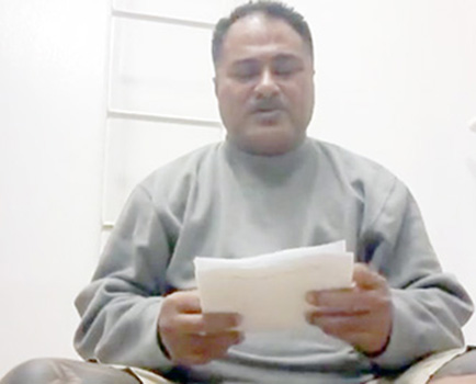 Samoa sailor, Puletiu  holds up a paper from his employer