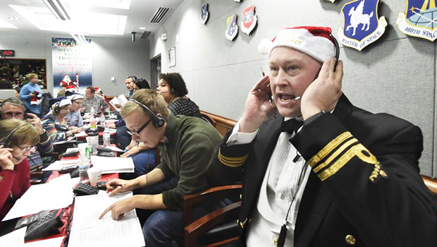 Canadian Lt. Maj. Chris Hache takes a call while volunteering at the NORAD Tracks Santa center 
