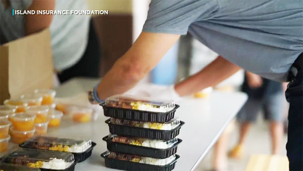 Man stacks meals in containers
