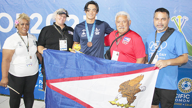 Micah with medal and others