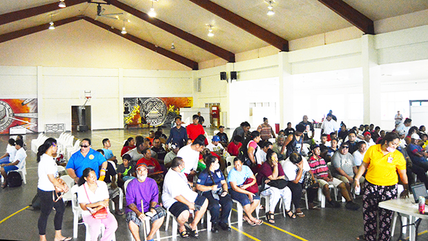 People seated waiting for their turn to get covid vaccination