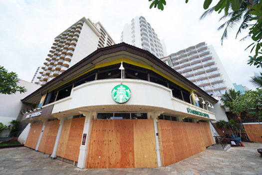 A Waikiki Starbucks coffee shop near Kapahulu Avenue with windows boarded up