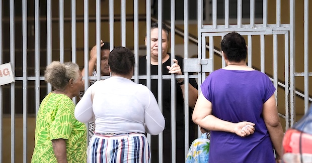 Papali‘i Sia Figiel looking through bars