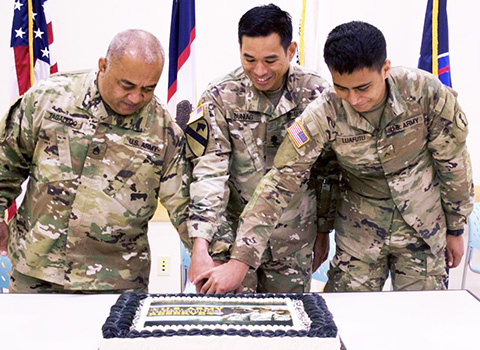 Staff Sgt. Faiupu Tagaleoo, assigned to Theater Support Group American Samoa Detachment, 9th Mission Support Command (left), representing the oldest unit member, and Pvt. Vend Luafutu, assigned to Charlie Company, 100th Battalion, 442nd Infantry Regiment, 9th Mission Support Command (right), along with Lt. Col. Alejandro Buniag, Commander, Theater Support Group American Samoa Detachment