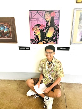 Talanoa Lagafuaina poses next to his most recent art
