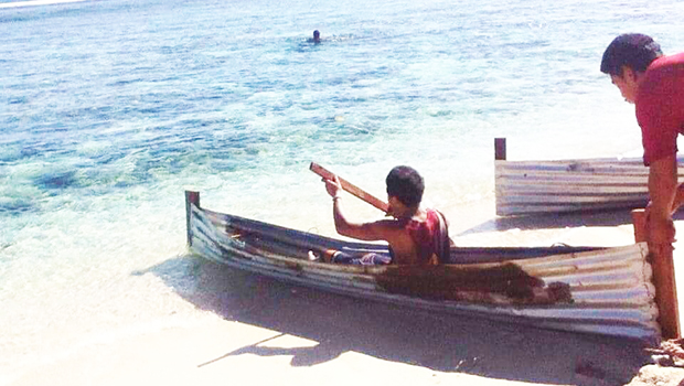 Ta'u kid with his va'a apa 