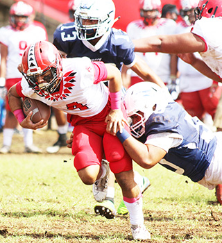 A Samoana defender brings down the Vikings ball carrier