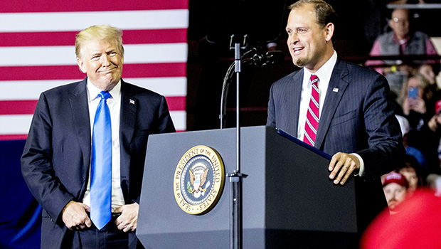 President Donald Trump, left, listens as Rep. Andy Barr, R-Ky., right, speaks at a rally 