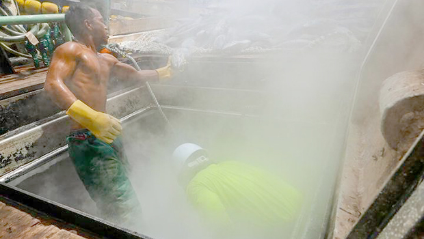 Two tuna fishermen working on deck