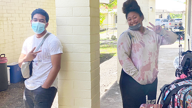 two people givine the V sign