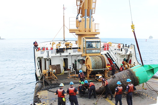 Juniper's crew servicing the green bouy at the entrance to Pago Pago harbor.