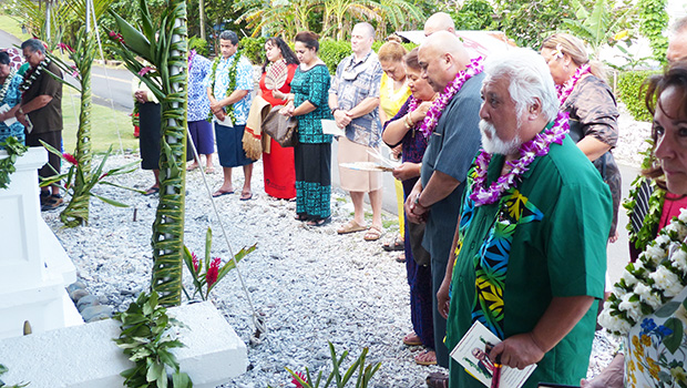Utu Abe Malae's gravesite surrounded by people who attended his 1 year memorial service