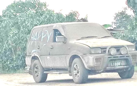 Van covered with ash