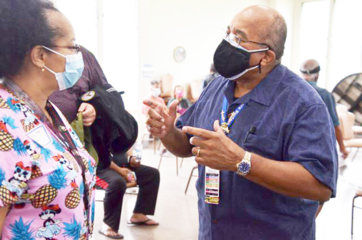 Dr. Adam Robinson, right, talks to a nurse