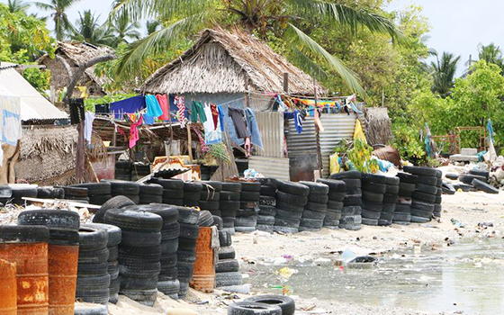 Village with tires protecting coastline from rising ocean tides