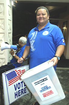 Woman carrying voting boxes