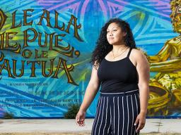Leah McKenzie, of Long Beach standing before the mural.