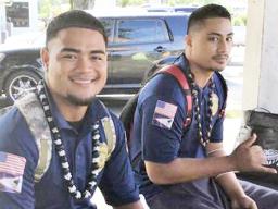 Two young men at bus stop