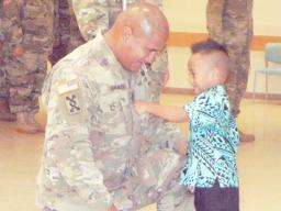 Newly pinned 1ST Sgt. Nathan Magalei of the 411th Engineer Battalion of the local U.S. Army Reserve and his son, Eisa Magalei, who had the honor of pinning his father