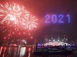 Fireworks and drones illuminate the night sky over London