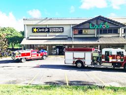 Fire trucks and EMS personnel in front of Carl's Jr