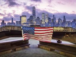 A U.S. flag hanging from a steel girder, damaged in the Sept. 11, 2001