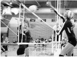 Hannah Beam (shown above, at right) sends a kill attempt over the net in a league match on Tuesday night. After smooth sailing early, Beam and the teanm adjusted in the midst of some adversity and stayed on track to get the sweep.