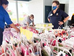 Lions Club members assemble gift packages 