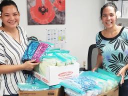 Elenor Lutu-McMoore (left) and Christinna Lutu-Sanchez with gowns and masks