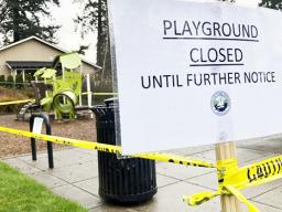 Police caution tape surrounds a playground in Lake Oswego, Ore.